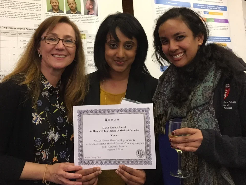 Three women holding David Rimoin Award